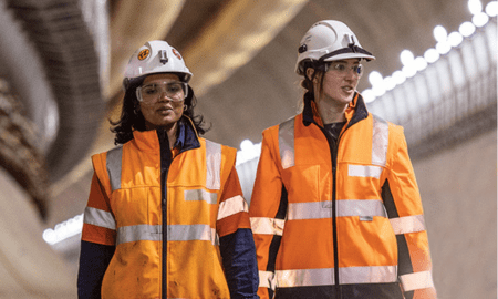 Two women in high-vis clothing in tunnel construction site