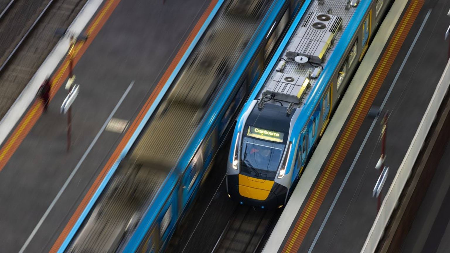 Metro train travelling through a train station Metro train travelling through a train station