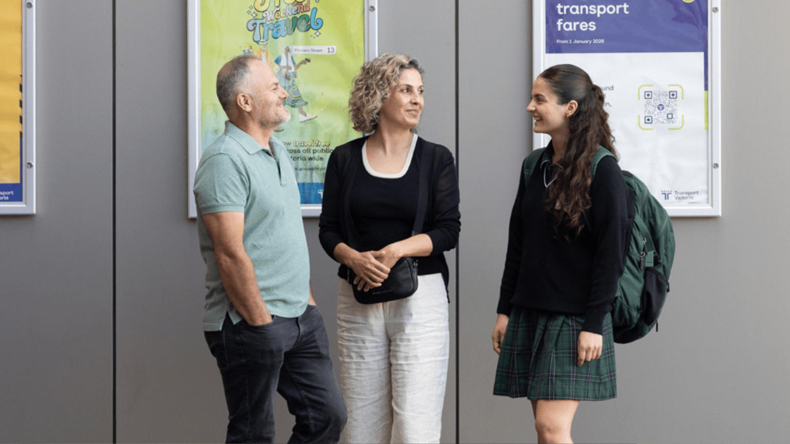 Family standing on a train station platform